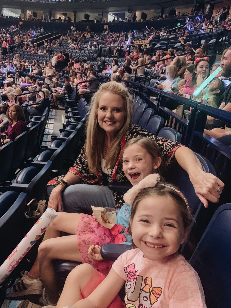 The Friday Five...by popular Nashville life and style blog, Hello Happiness: image of two girls at a Jojo Siwa concert and wearing Walmart Jojo Siwa Unicorn Fashion Top and Tutu Skirt, 2-Piece Outfit Set, Jojo Siwa Foil Mesh Dress, and Target Cat & Jack Girls' Long Sleeve Striped Sequin Bomber Jacket.