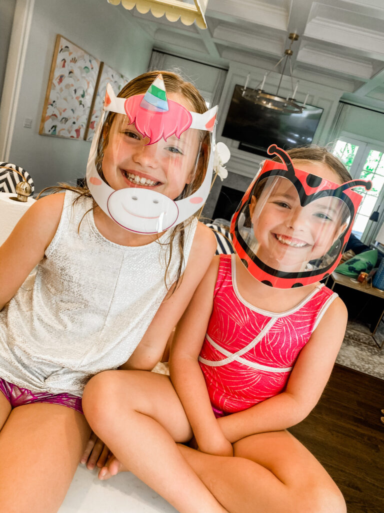 Small Shops by popular Nashville life and style blog, Hello Happiness: image of two girls wearing a unicorn and lady bug The Vision Visor.