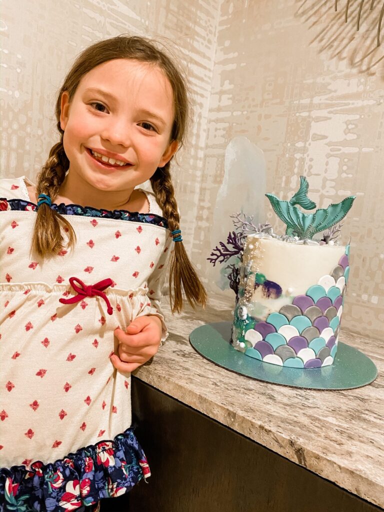Gaylord Soundwaves by popular Nashville lifestyle blog, Hello Happiness: image of a young girl standing next to a mermaid birthday cake. 