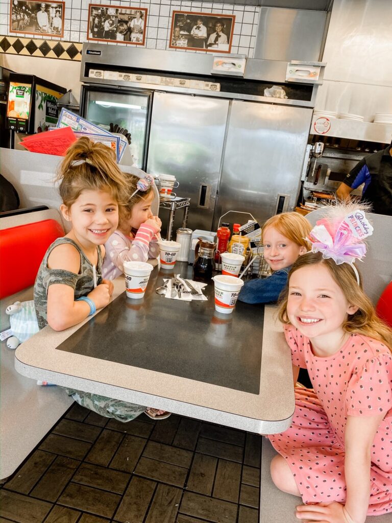 Gaylord Soundwaves by popular Nashville lifestyle blog, Hello Happiness: image of four young girls sitting at a diner table at the Gaylord Opryland Resort. 