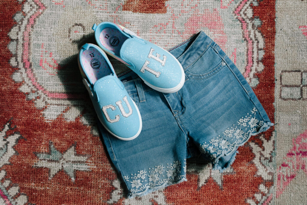 Walmart Back to School by popular Nashville life and style blog, Hello Happiness: image of Walmart CUTE slip on sneakers and scallop embroidered shorts. 