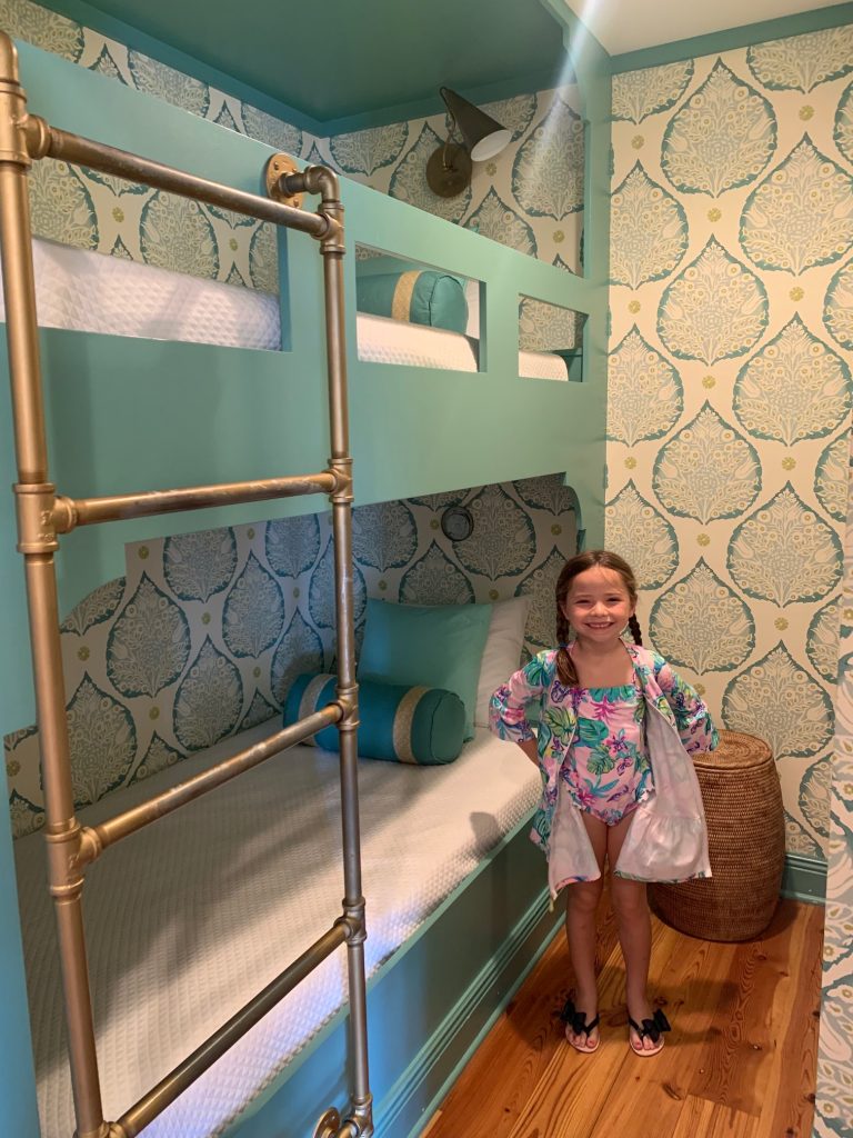 Finding Our Dream Home Away From Home... Rosemary Beach Realty by popular Nashville travel blog, Hello Happiness: image of a little girl standing next to some blue bunk beds. 
