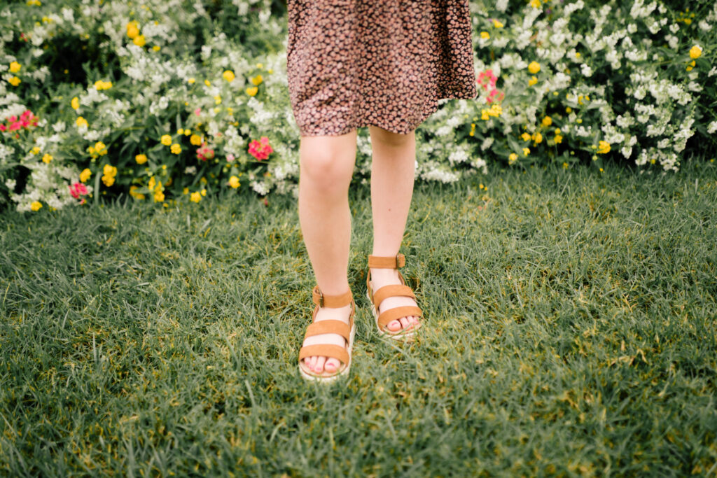 Tween Fashion by popular Nashville fashion blog, Hello Happiness: image of a girl standing outside and wearing a Target Skater ditsy print swing dress, black and white stripe knot headband, and platform espadrilles. 