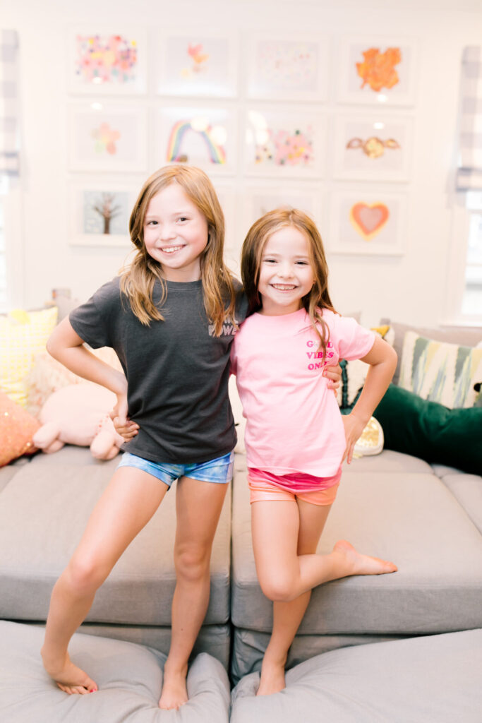Year in Review by popular Nashville lifestyle blog, Hello Happiness: image of two young girls standing together on a couch and wearing activewear. 