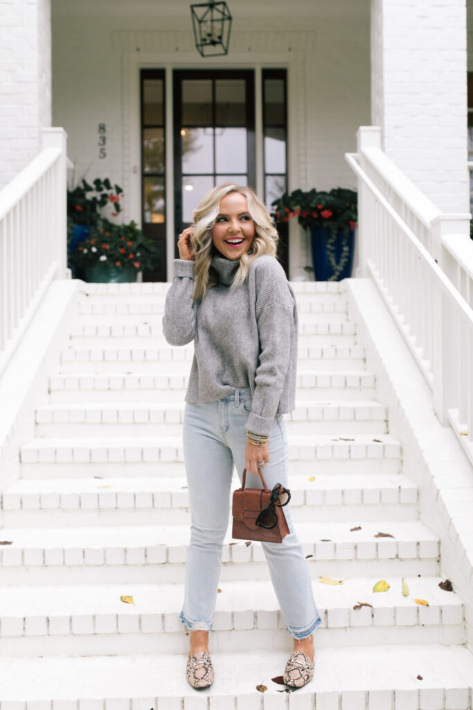 Fall Wardrobe by popular Nashville fashion blog, Hello Happiness: image of Natasha Stoneking standing on her front porch steps and wearing a Walmart Dreamers by Debut Women's Cowl Neck Sweater, Walmart Scoop Women’s Destructed Release Hem Crop Flare Jeans, Walmart Time and Tru Bit Loafer, and holding a Walmart Scoop Women's Faux Croco Top Handle Mini Crossbody Bag. 