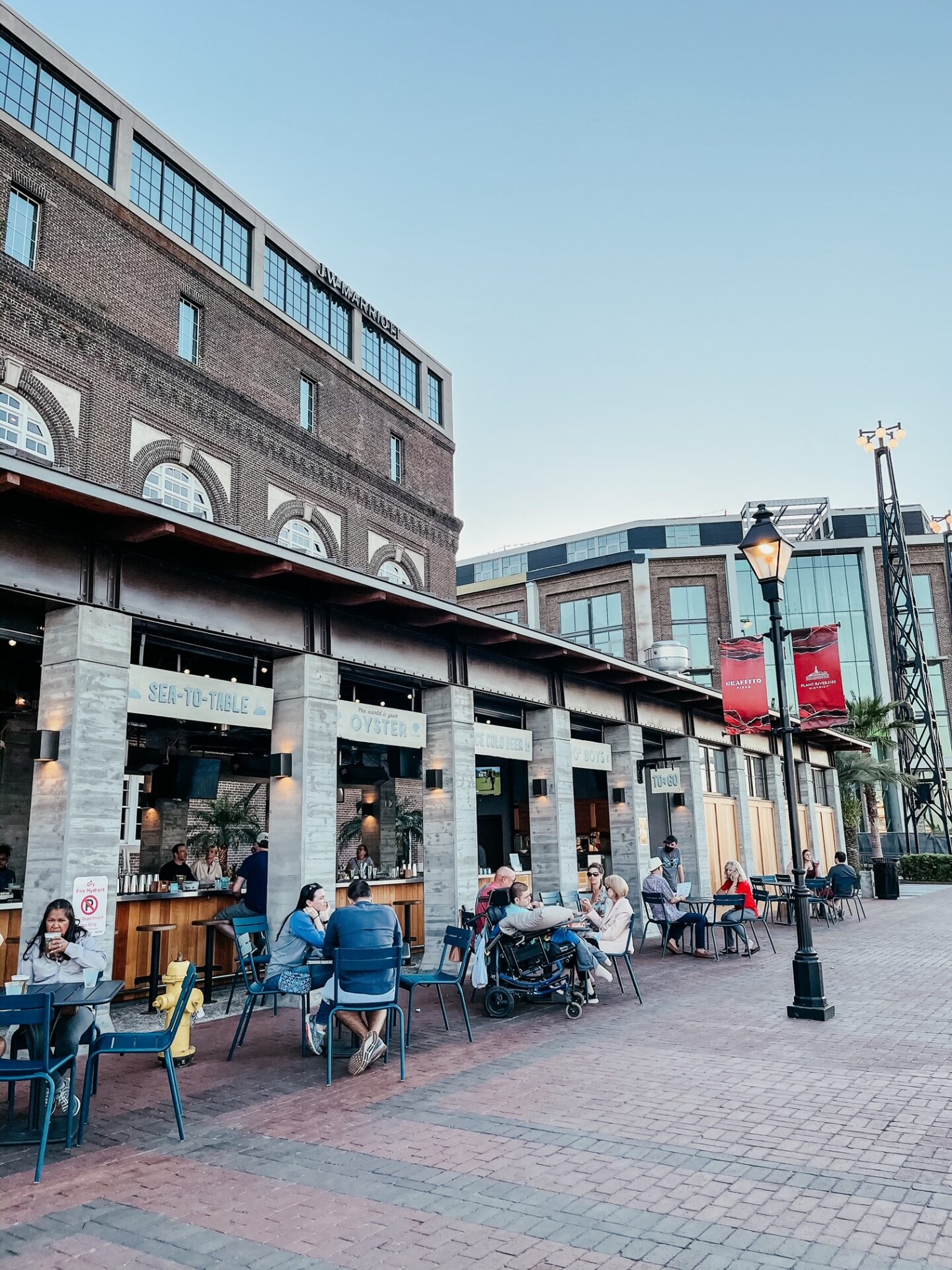 Girls Getaway by popular Nashville travel blog, Hello Happiness: image of a group of people eat outside at a seafood restaurant. 