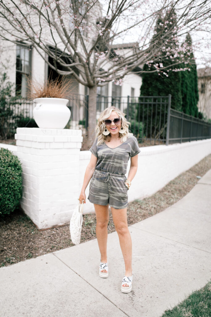 Z Supply by popular Nashville fashion blog, Hello Happiness: image of a woman wearing a Z Supply camo blaire romper, snakeskin espadrilles, cotton cord bag, raffia earrings.