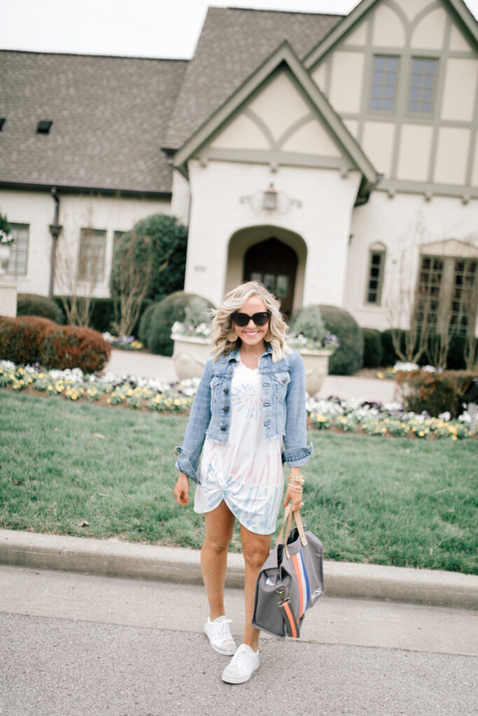 Z Supply by popular Nashville fashion blog, Hello Happiness: image of a woman wearing a Z Supply Naibi cropped jacket, tie dye side knot dress, tote-ally bag, and rezza sneakers.
