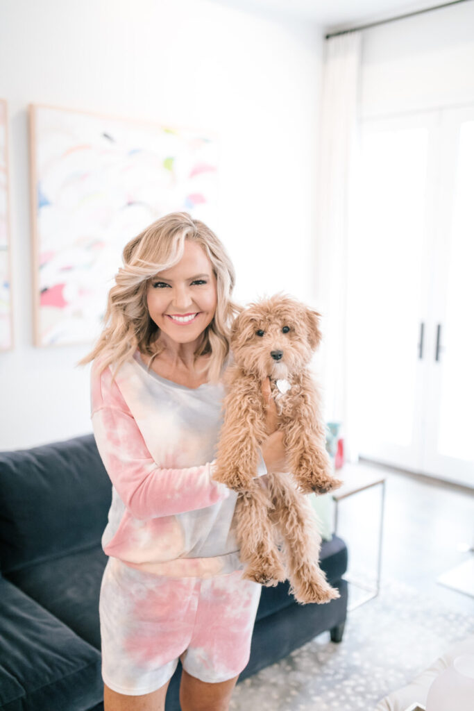 Spring Pajamas by popular Nashville fashion blog, Hello Happiness: image of a woman wearing Social Threads Phil Love Tie Dye Short Set and holding a dog. 