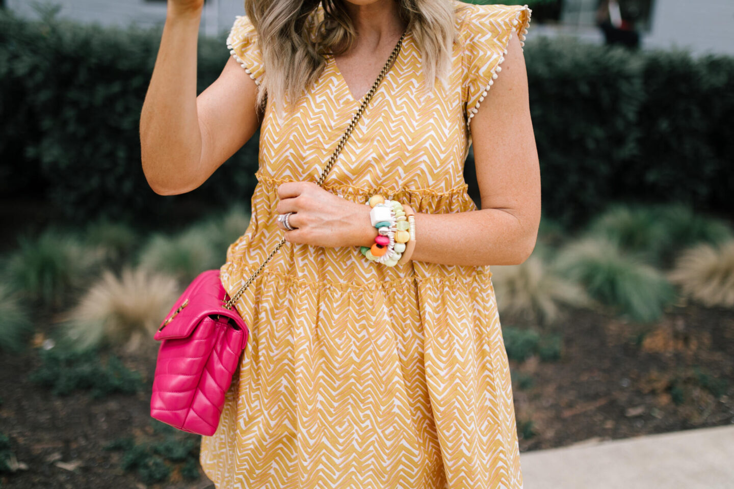 Summer Dresses by popular Nashville of Natasha Stoneking wearing a abstract flutter sleeve dress and carrying a YSL pink bag. 