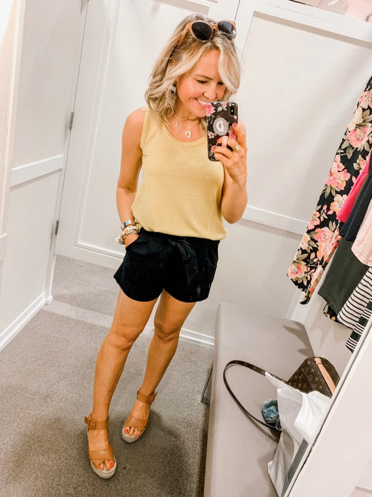 Ready, Set, SHOP! The Best in 4th of July Sales by popular Nashville fashion blog, Hello Happiness: image of woman standing inside of a changing room wearing Loft KNIT TIE WAIST SHORTS and CUTOUT BACK TANK.