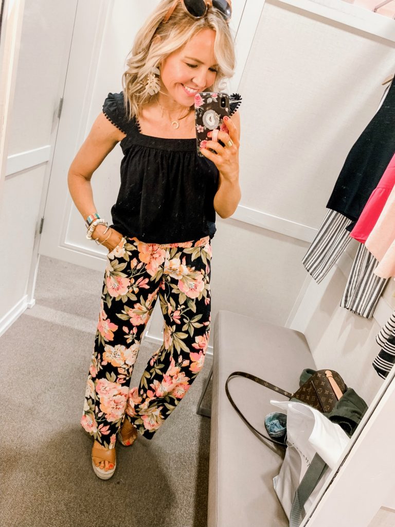 Ready, Set, SHOP! The Best in 4th of July Sales by popular Nashville fashion blog, Hello Happiness: image of woman standing inside of changing room wearing a Loft EYELET TRIM FLUTTER TANK and Loft FLORAL FLUID WIDE LEG PANTS.
