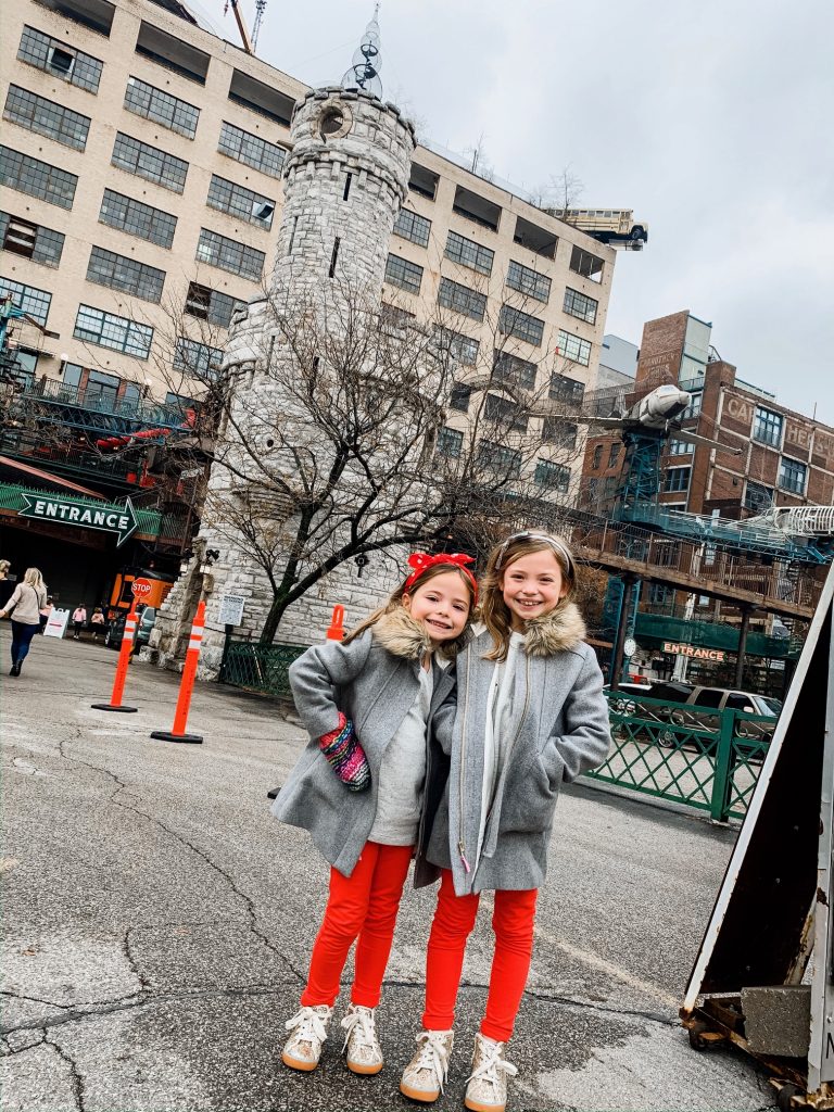 Meet Me for a Weekend in St. Louis | The Perfect Family Getaway by popular travel blog, Hello Happiness: image of two girls standing in front of the St. Louis City Museum entrance. 