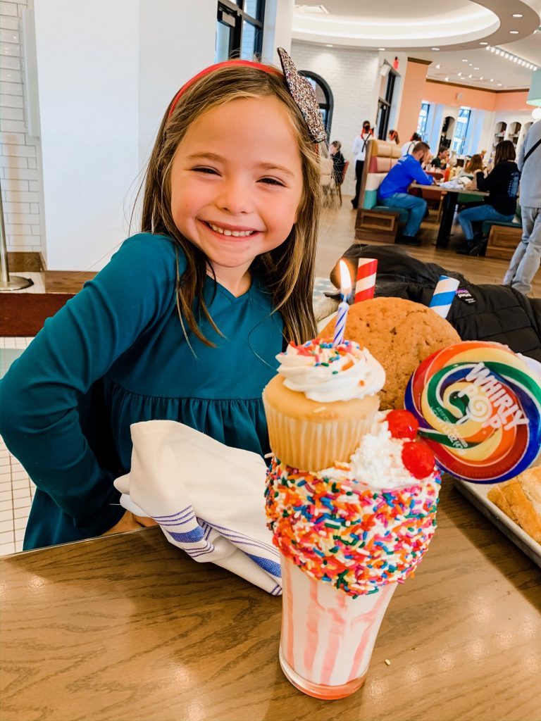 Meet Me for a Weekend in St. Louis | The Perfect Family Getaway by popular travel blog, Hello Happiness: image of a girl with an ice cream sundae at the Soda Fountain. 