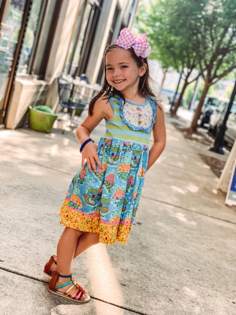 Memorial Day Sales by popular Nashville fashion blog, Hello Happiness: image of a little girl wearing a Matilda Jane Home Sweet Home dress. 