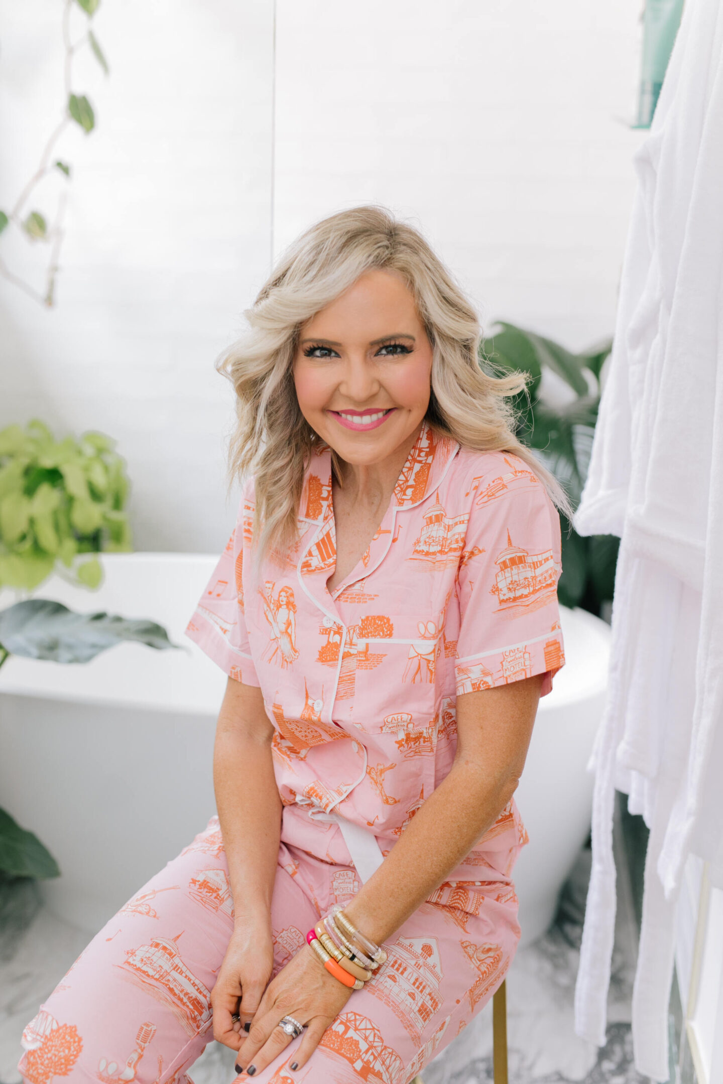 Collaborations and Partnerships by popular Nashville lifestyle blog, Hello Happiness: image of a woman wearing a pink and orange print pajama set. 