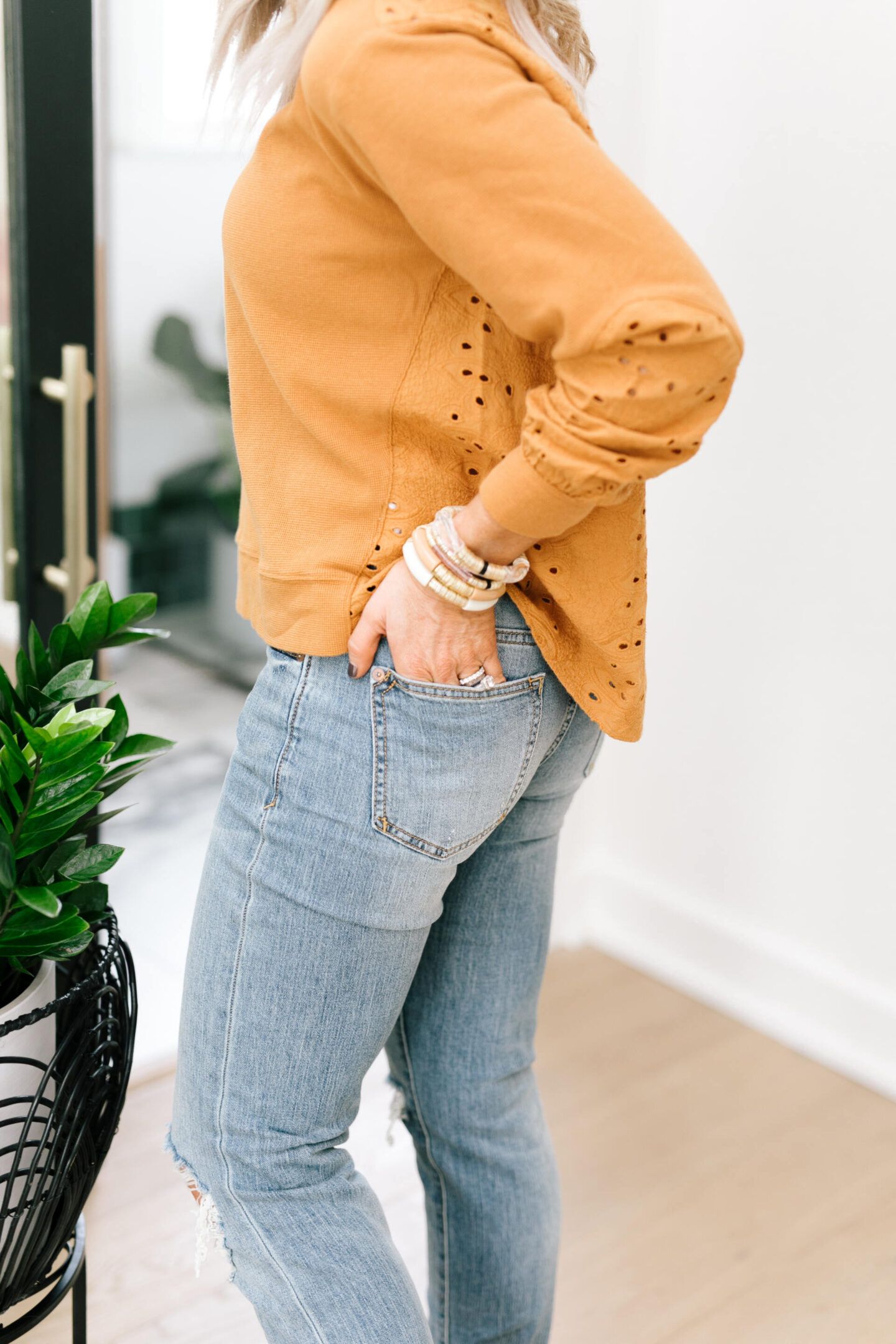 Anthro x Pilcro by popular Nashville fashion blog, Hello Happiness: image of Natasha Stoneking wearing some Anthro x Pilcro jeans and a orange eyelet long sleeve top. 