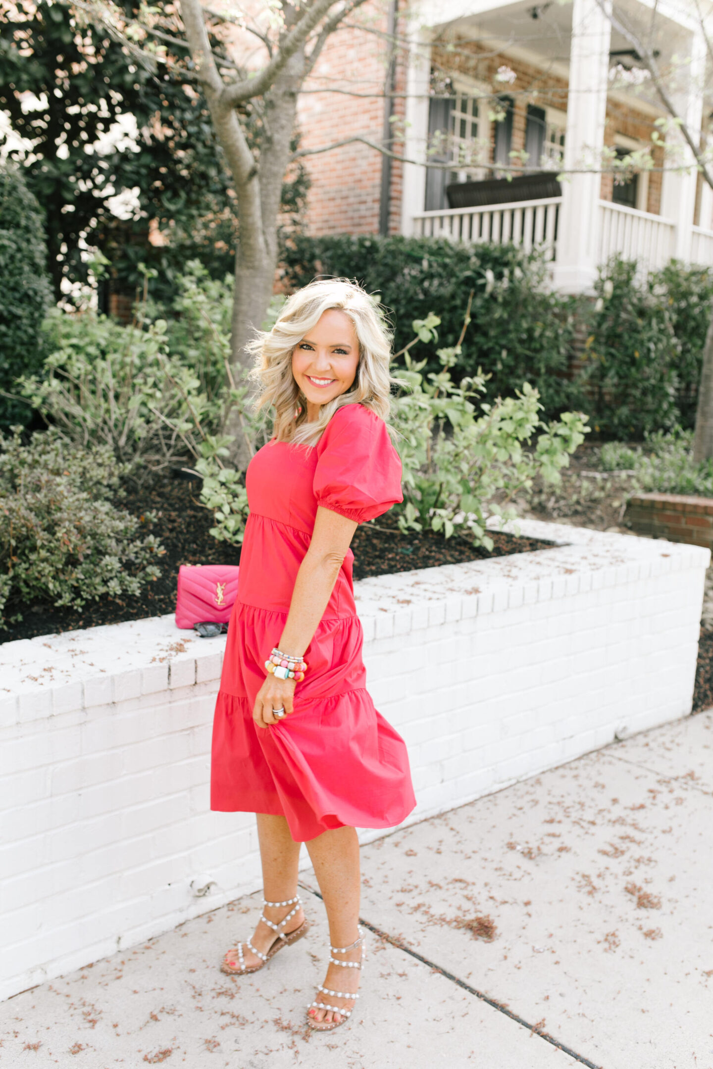 New Dress by popular Nashville lifestyle blog, Hello Happiness: image of a woman wearing a puff sleeve dress cake by the ocean bracelet, California girls bracelet, Hadley bracelet, after hours sunnies, pearl sandals, and holding a small loulou bag. 
