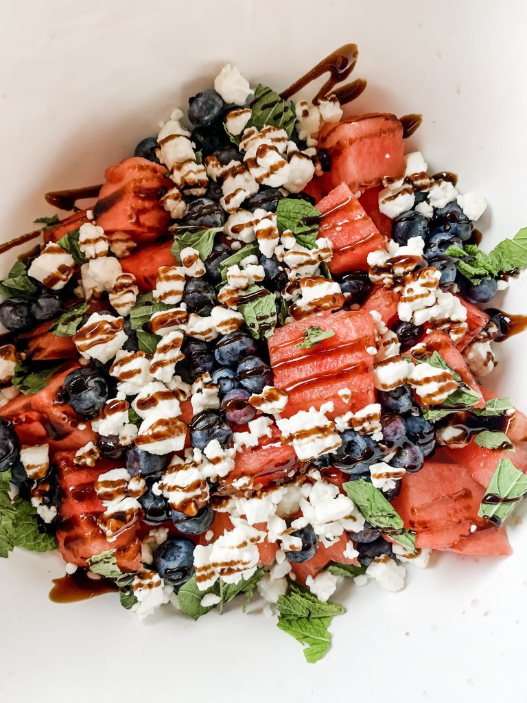 Quick Summer Salad with Watermelon, Blueberries and Feta by popular Nashville lifestyle blog, Hello Happiness: image of watermelon, blueberry and feta salad drizzled with balsamic vinegar glaze.