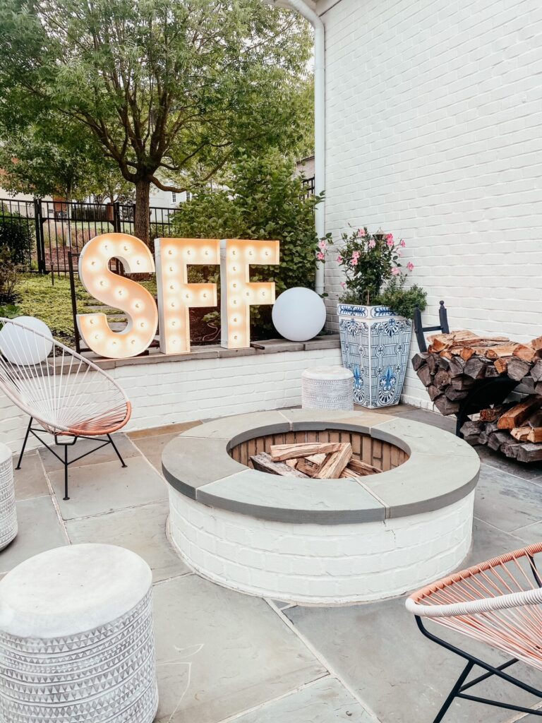 Dinner Party Ideas by popular Nashville lifestyle blog, Hello Happiness: image of marquee light letters, Frontgate Santorini Planters and CB2 ACAPULCO WHITE OUTDOOR CHAIR.  