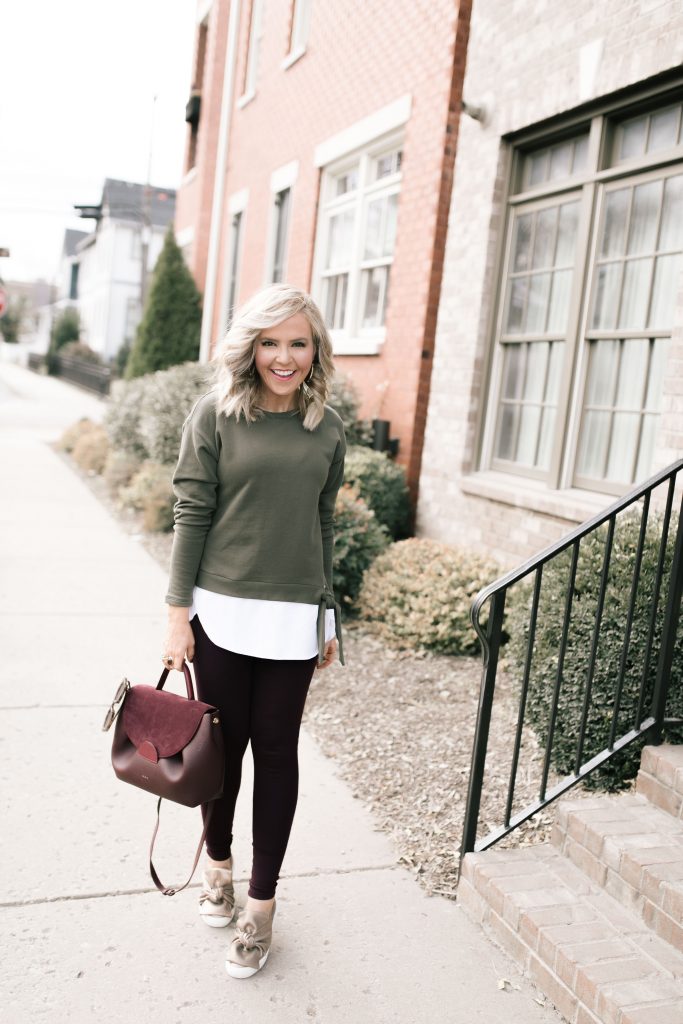 2019 Holiday Gift Guide | Best Cyber Week Sales and Deals by popular Nashville life and style blog, Hello Happiness: image of a woman outside wearing a Loft TIE HEM SWEATSHIRT and Loft HIGH WAIST LEGGINGS IN SEAMED PONTE.