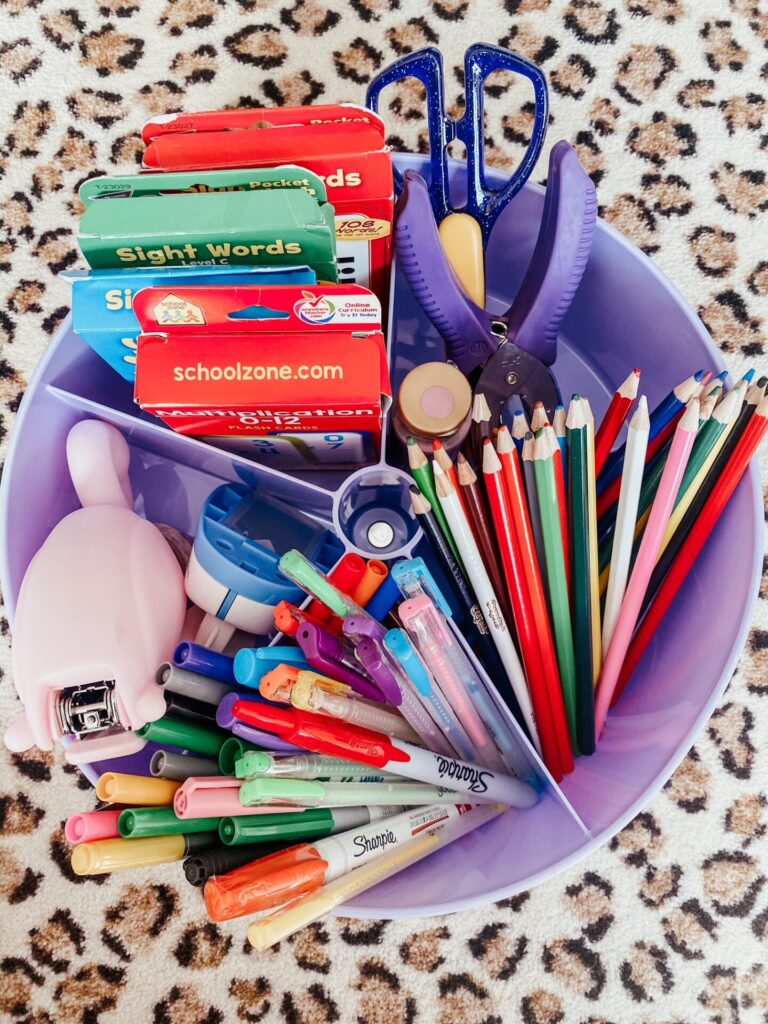 Year in Review by popular Nashville lifestyle blog, Hello Happiness: image of a purple caddy filled with colored pencils, gel pens, markers, scissors, tape, sight word cards. 