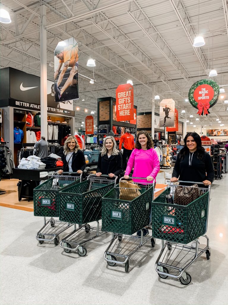 Unwrap the Magic of Sports with Dick's Gift Ideas by popular Nashville life and style blog, Hello Happiness: image of four women pushing Dick's shopping carts. 