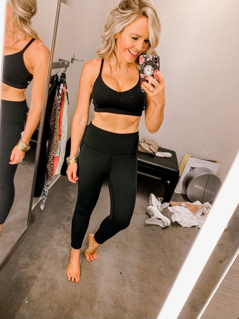 It's LIVE, The 2019 Nordstrom Anniversary Sale... First Look Favs + Dressing Room Diaries by popular Nashville fashion blog, Hello Happiness: image of a woman standing in a Nordstrom dressing room and wearing a Zella Studio Lite Crop Leggings and Zella Live-In Sports Bra.