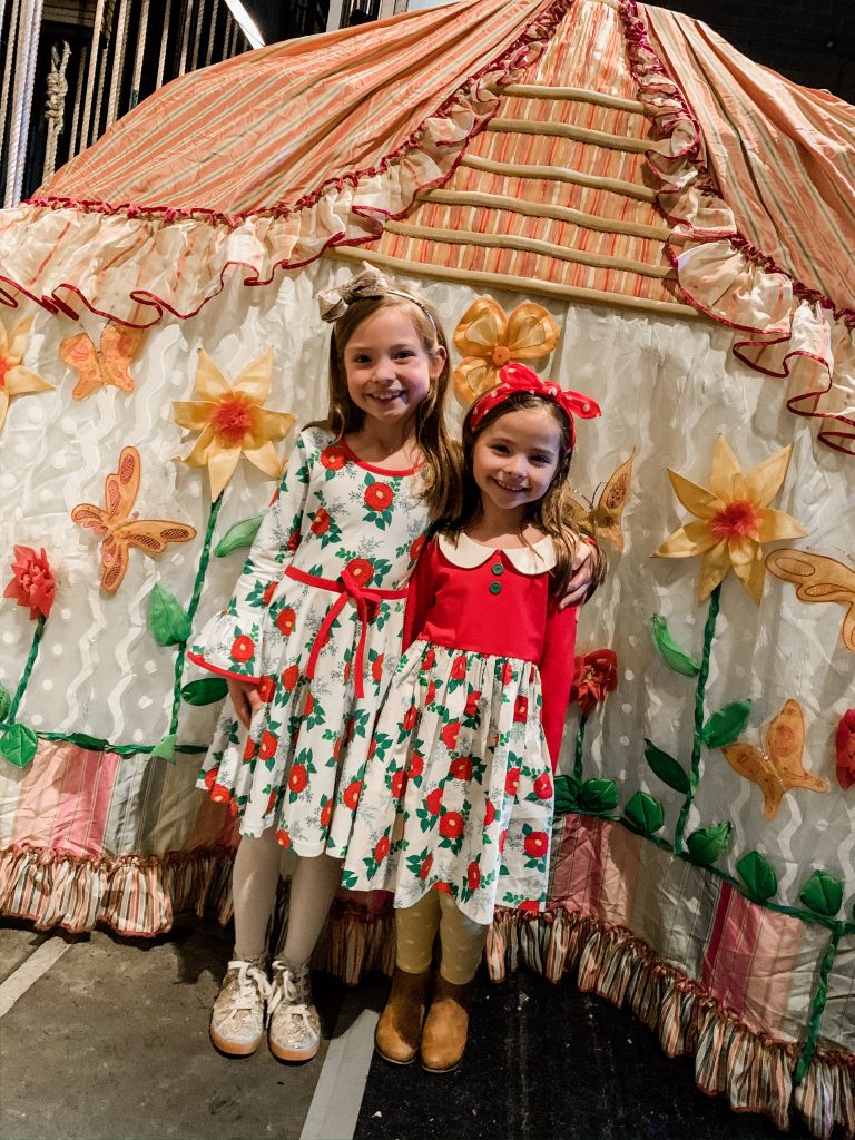All Our Favorite Family Holiday Traditions by popular life and style blog, Hello Happiness: image of image of two girls wearing Eleanor Rose Christmas Rose dresses. 