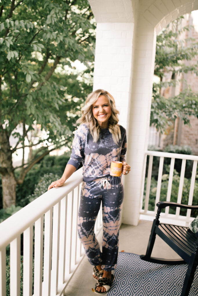 Pet Peeves by popular Nashville lifestyle blog, Hello Happiness: image of Natasha Stoneking standing out on her patio and wearing a Silent Night Tie Dye Set, Criss Cross faux fur sandals and holding a Kindness mug.  