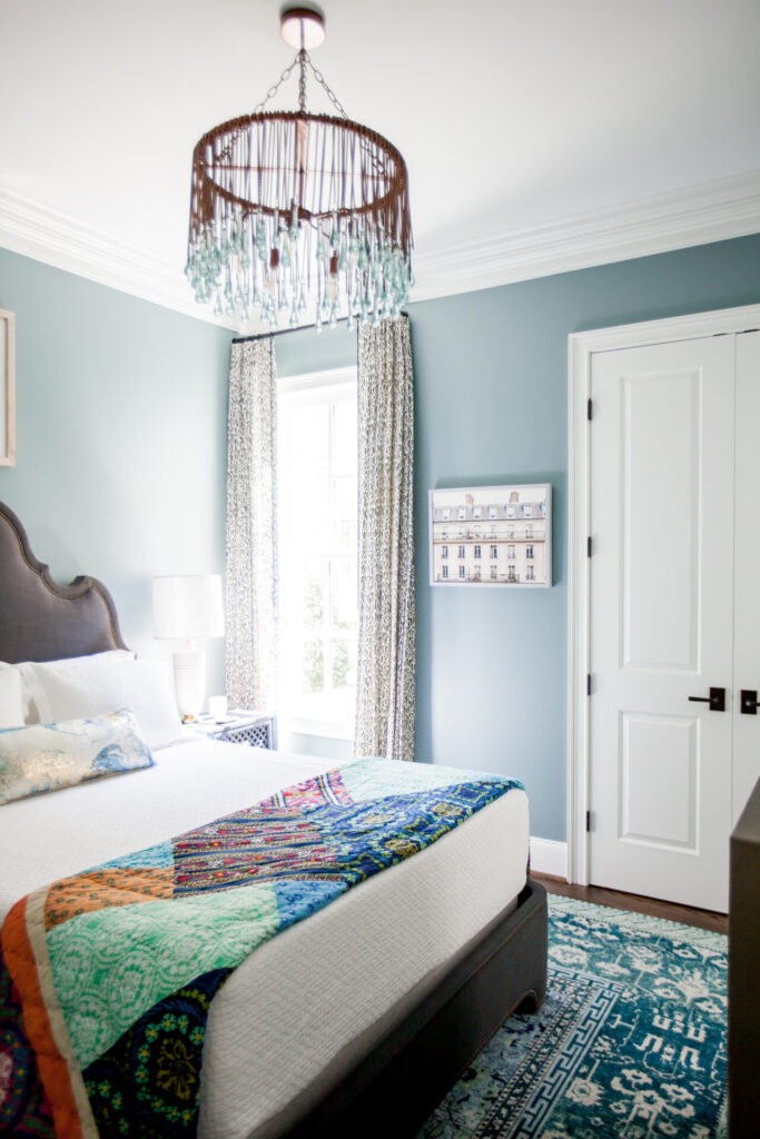 Anthropologie Sale by popular Nashville life and style blog, Hello Happiness: image of a bedroom decorated with a Anthropologie Tallis Teardrop Chandelier and a Anthropologie patchwork quilt. 