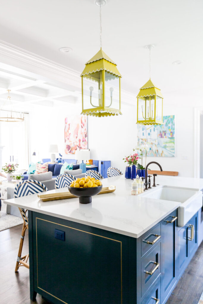 Pet Peeves by popular Nashville lifestyle blog, Hello Happiness: image of a kitchen with a blue island, yellow pendant lights, blue and white strip bar stools, and wood floors. 