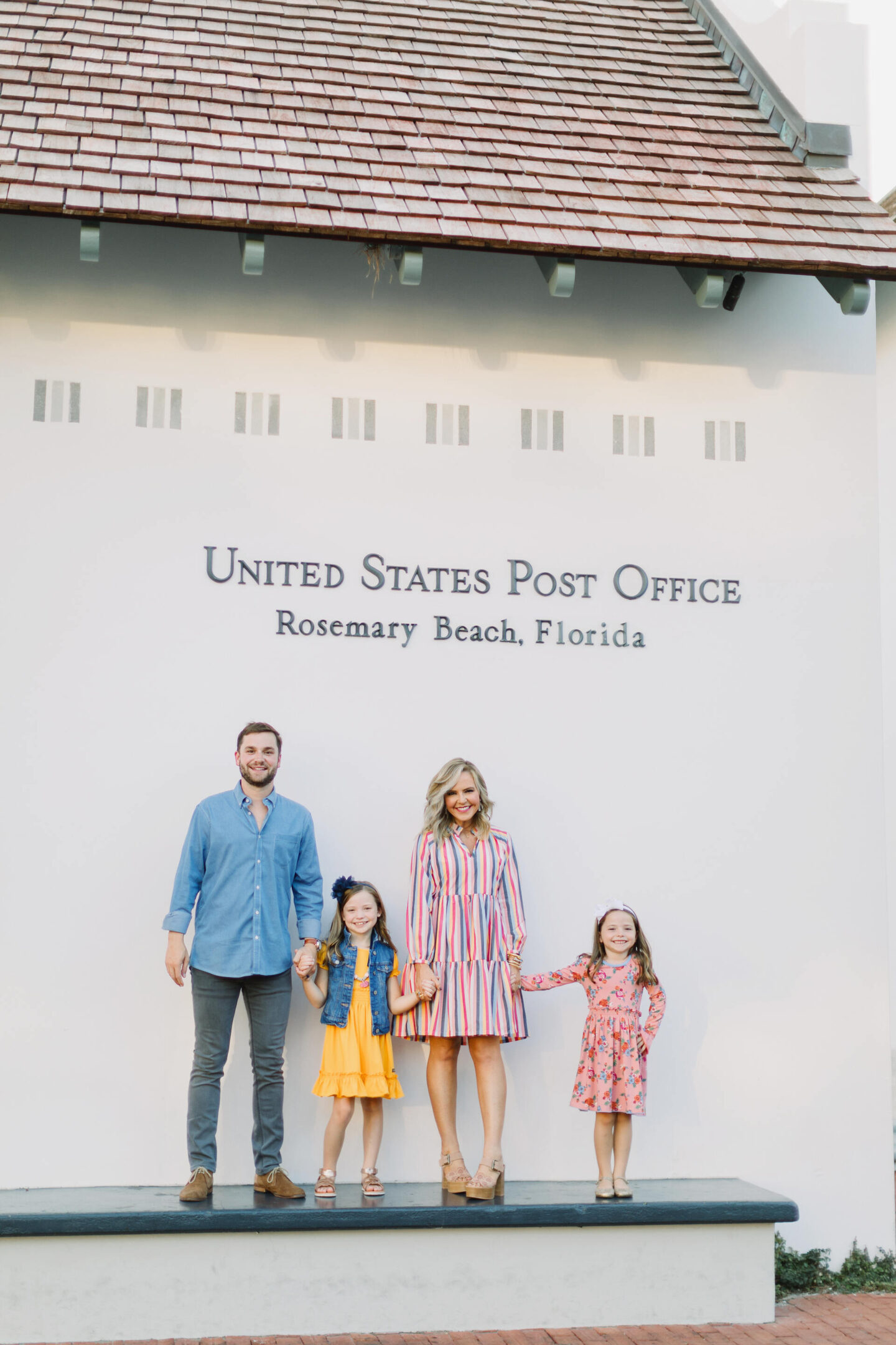 All About Me by popular Nashville lifestyle blog, Hello Happiness: image of a family standing next to the Rosemary Beach United States post office. 