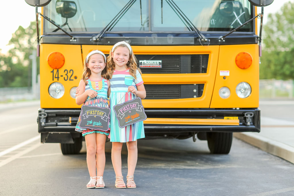 Year in Review by popular Nashville lifestyle blog, Hello Happiness: image of two girls standing together in front of a yellow school bus. 