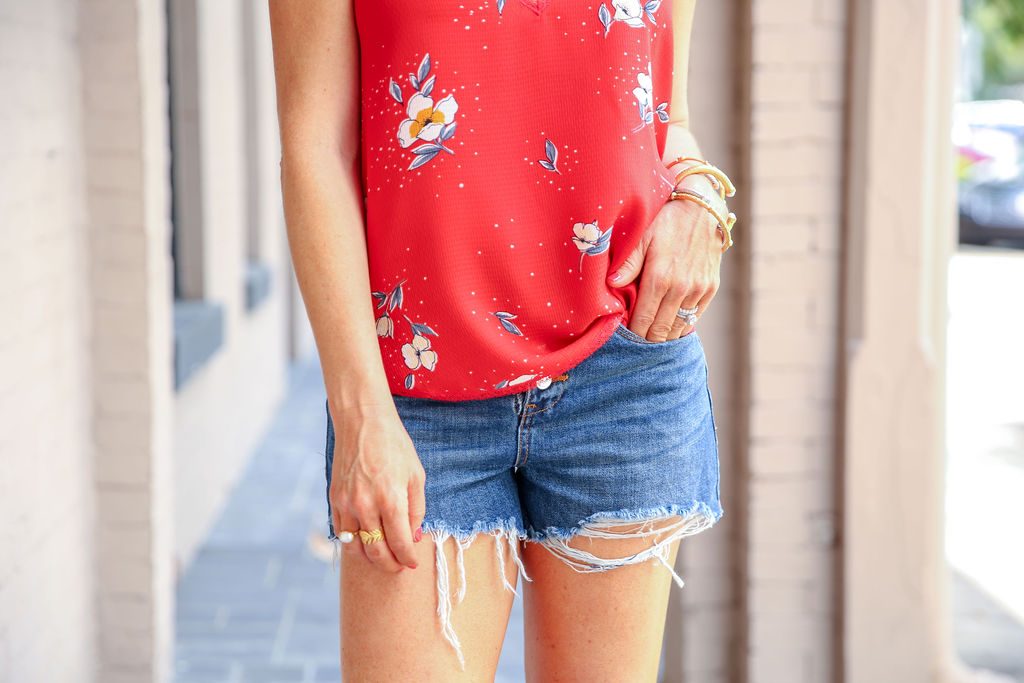 Summer Capsule Wardrobe featured by top US fashion blog Hello! Happiness; Image of a woman wearing Social Threads red floral cami and Blank NYC jean shorts.